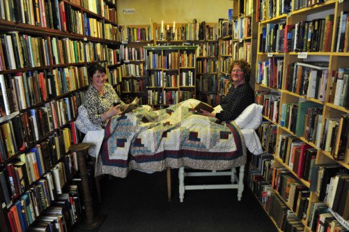 Nicky McDonald, manager of the Book Shop in Wigtown, with owner Shaun Bythell in the festival's bookshop bed. Picture: Robert Perry
